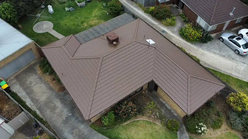After: a smooth brown tile roof, repainted, seen from above