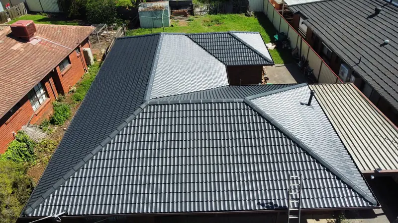After: a charcoal tile roof, repainted, seen from above