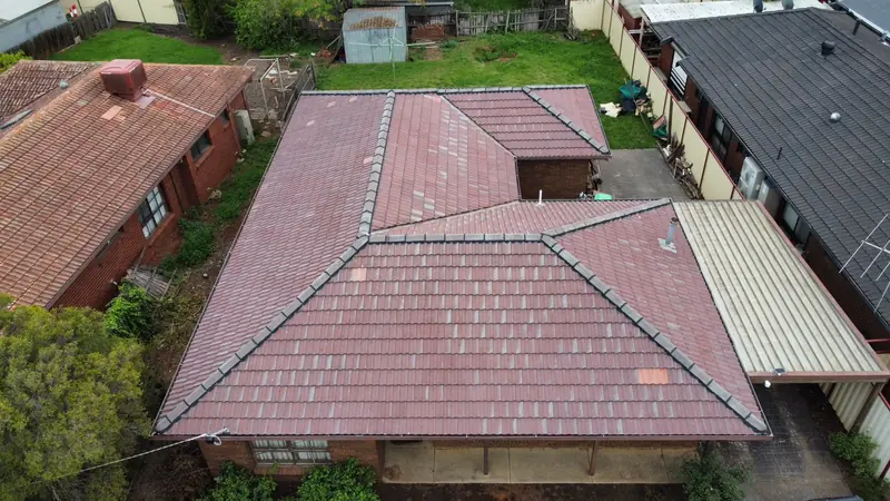 Before: a faded red-brown tile roof, seen from above