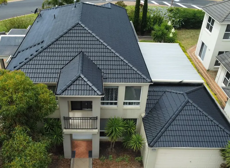 After: a charcoal tile roof on a two-storey home, repainted, seen from above