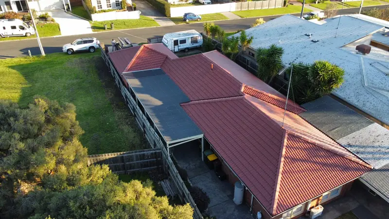 After: a red tile roof, repainted, seen from above