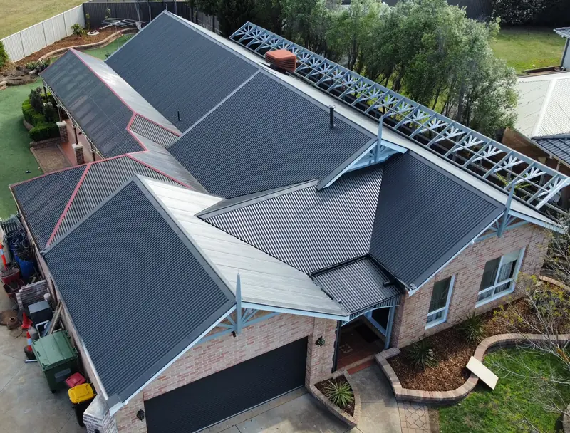 After: a dark grey corrugated roof, coated, seen from above